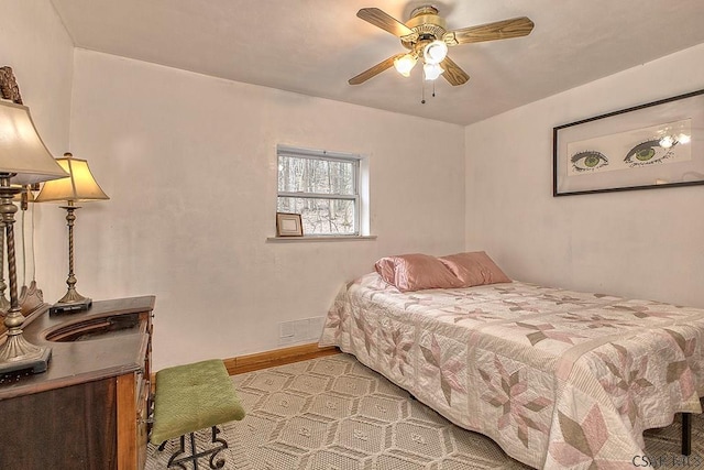 bedroom featuring baseboards and a ceiling fan