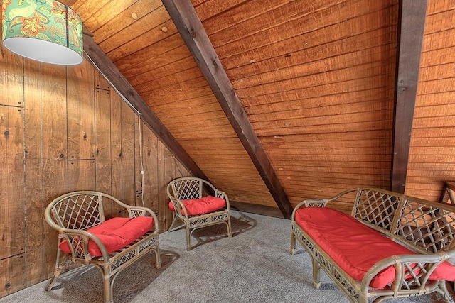 living area with lofted ceiling with beams, carpet floors, wood ceiling, and wood walls