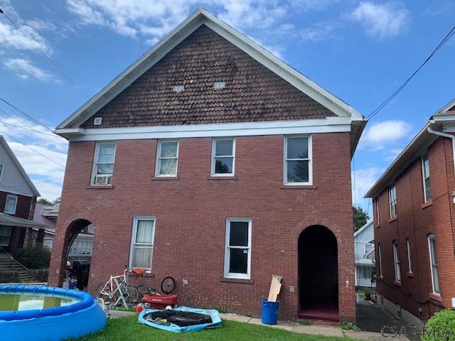 exterior space with a front yard and brick siding