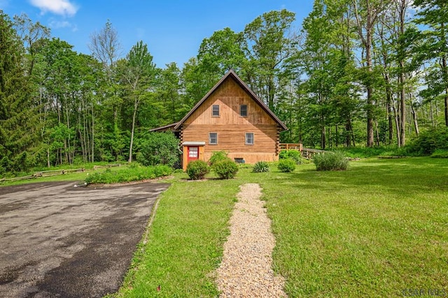 2484 Berlin Plank Rd, Berlin, PA 15530 - view of home's exterior featuring log siding, a yard, driveway, and a wooded view