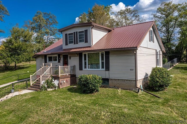 view of front of property with metal roof, a front lawn, and fence