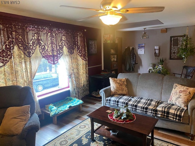 living area with ceiling fan and wood finished floors