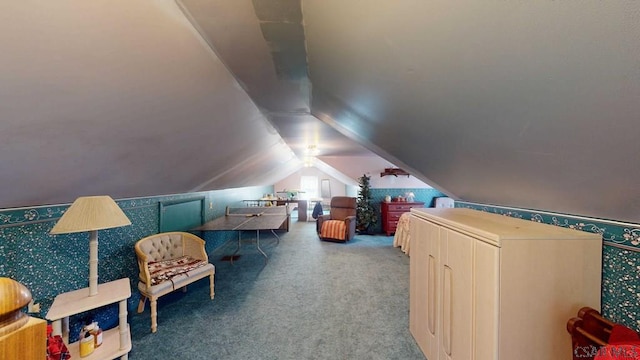 interior space featuring carpet floors, wallpapered walls, and vaulted ceiling