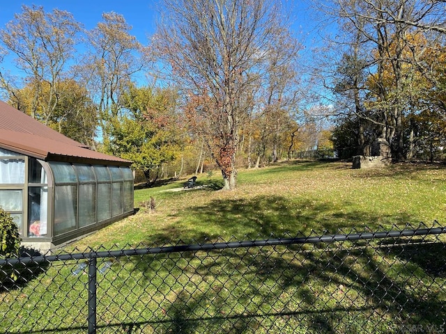 view of yard with an outbuilding, an exterior structure, and fence