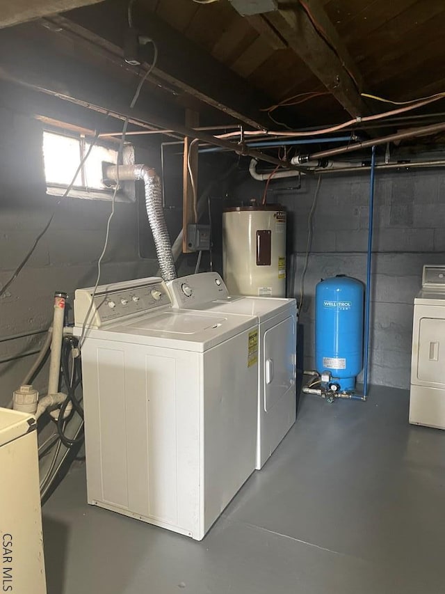 washroom with water heater, laundry area, and washing machine and clothes dryer