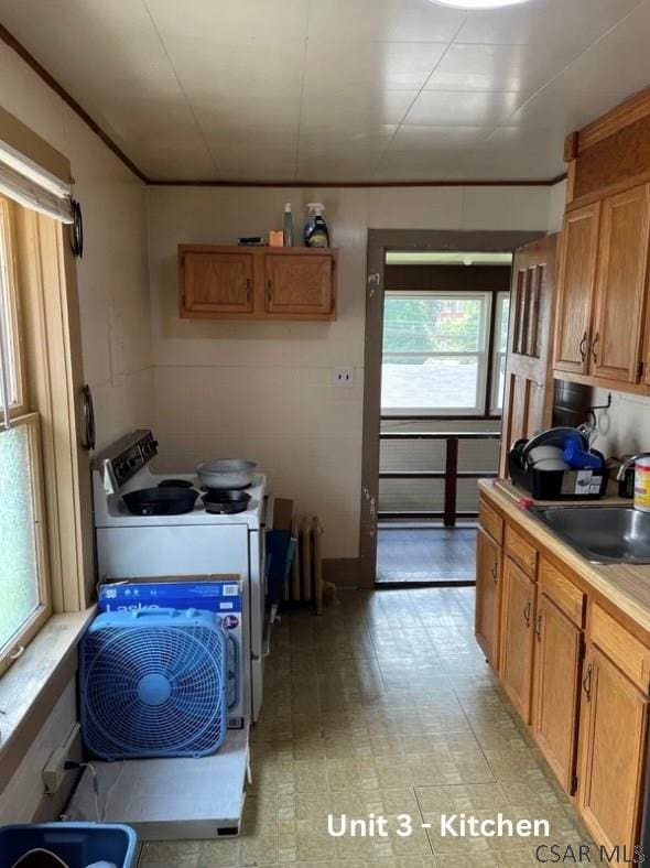 1804 Somerset Ave, Windber, PA 15963 - kitchen with white stove, a sink, plenty of natural light, and light countertops