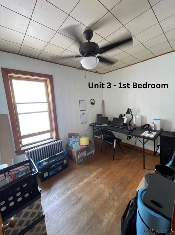 1804 Somerset Ave, Windber, PA 15963 - home office featuring radiator heating unit, hardwood / wood-style flooring, and a ceiling fan