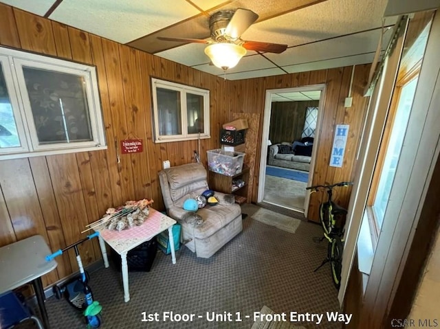 1804 Somerset Ave, Windber, PA 15963 - living area with wood walls, a ceiling fan, and carpet flooring