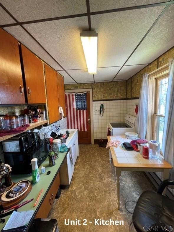 1804 Somerset Ave, Windber, PA 15963 - kitchen featuring stove, tile countertops, and brown cabinets