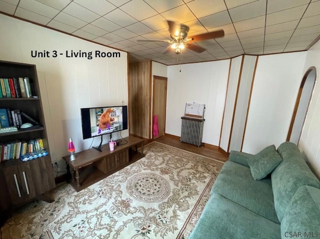 1804 Somerset Ave, Windber, PA 15963 - living room featuring a ceiling fan, wood finished floors, and radiator