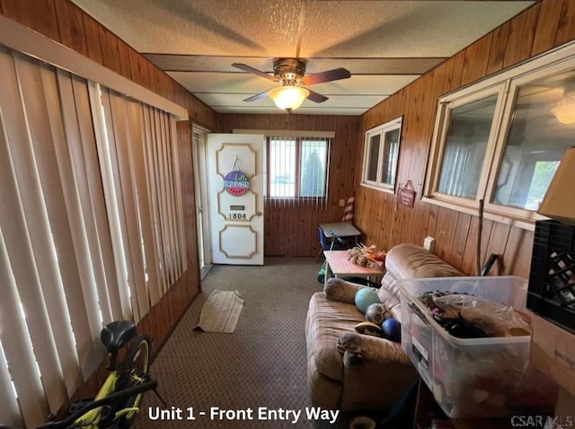 1804 Somerset Ave, Windber, PA 15963 - carpeted living area featuring a ceiling fan, wooden walls, and a textured ceiling