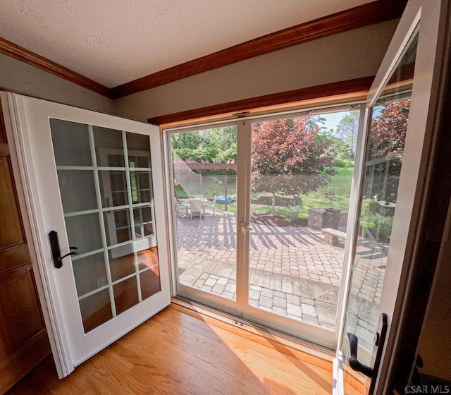 3056 Menoher Blvd, Johnstown, PA 15905 - doorway to outside with crown molding, wood finished floors, and a textured ceiling