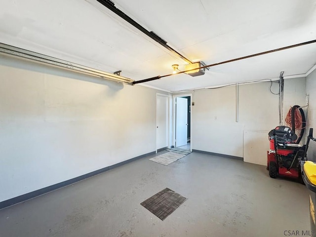 garage with baseboards and a garage door opener