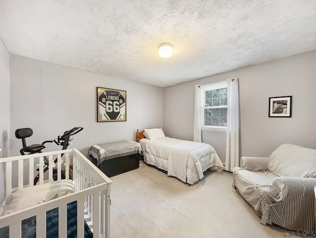 bedroom featuring carpet and a textured ceiling