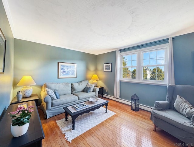 living area featuring baseboards, wood-type flooring, a textured ceiling, and a baseboard radiator