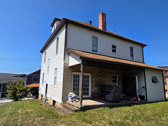 rear view of property featuring a yard