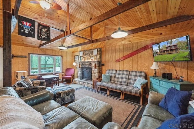 1036 Causeway Dr, Friedens, PA 15541 - carpeted living area with wood ceiling, wooden walls, beamed ceiling, a ceiling fan, and a fireplace
