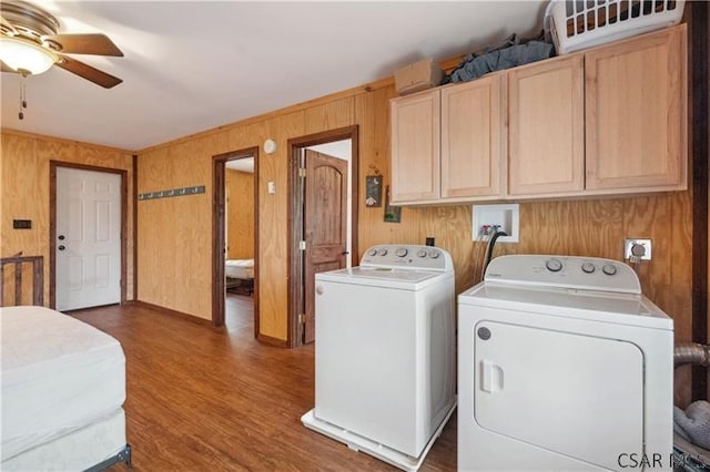 1036 Causeway Dr, Friedens, PA 15541 - clothes washing area with cabinet space, washing machine and clothes dryer, wooden walls, a ceiling fan, and dark wood-style flooring