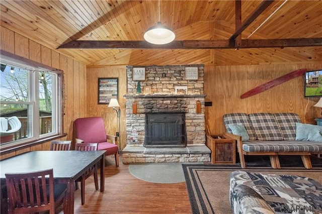 1036 Causeway Dr, Friedens, PA 15541 - living room with wooden walls, wood finished floors, a stone fireplace, and wood ceiling