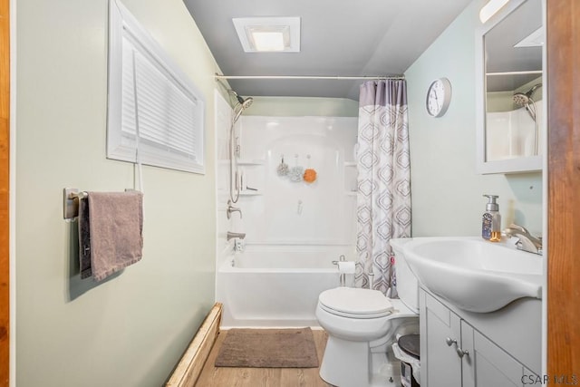 bathroom with shower / bath combination with curtain, wood finished floors, vanity, and toilet