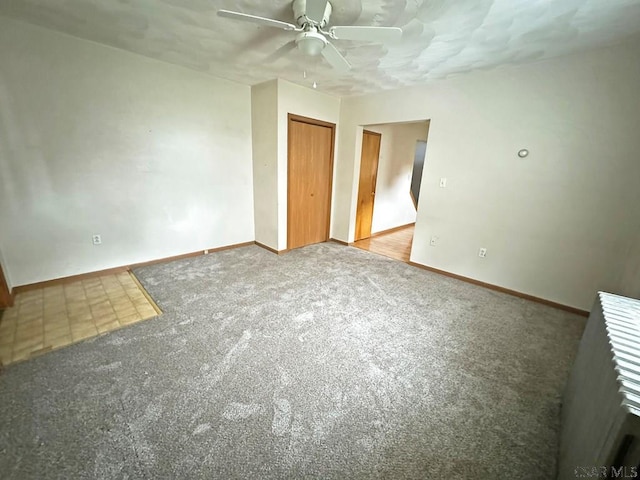 empty room featuring carpet and ceiling fan