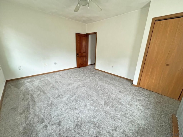 unfurnished bedroom featuring carpet flooring, ceiling fan, and a closet