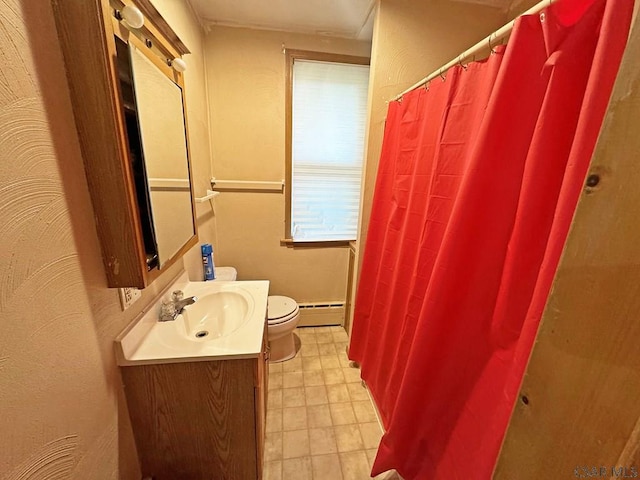 bathroom featuring baseboard heating, vanity, and toilet