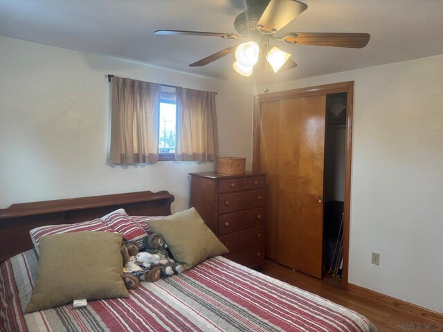 bedroom with ceiling fan, a closet, and wood finished floors