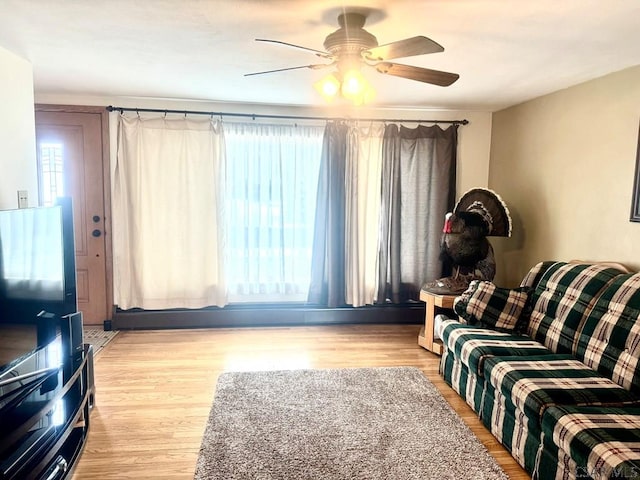 living area featuring ceiling fan and wood finished floors