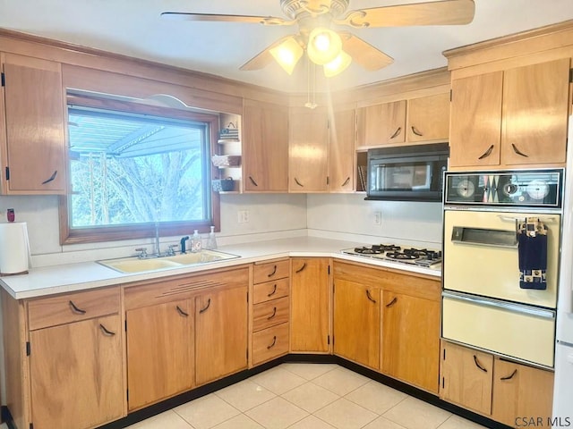 kitchen with white appliances, light countertops, a sink, and a warming drawer