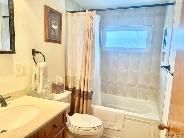 bathroom with a textured wall, vanity, toilet, and shower / bathtub combination with curtain