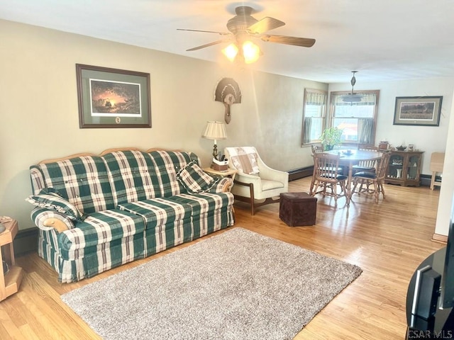 living area with ceiling fan and wood finished floors