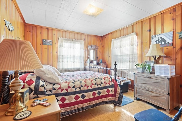 bedroom featuring ornamental molding and wooden walls