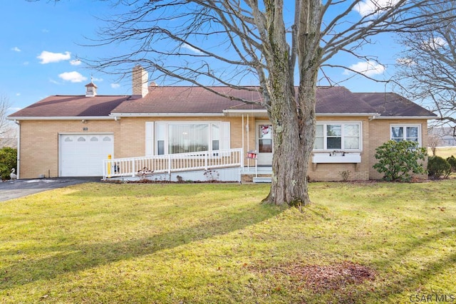 ranch-style house featuring a garage, a front yard, and a porch