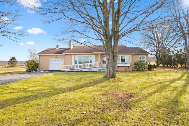 ranch-style house with a garage and a front yard