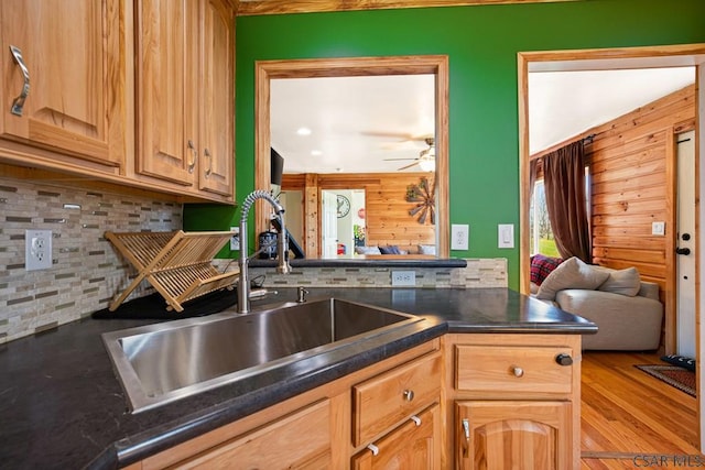 1070 Huckleberry Hwy, Central City, PA 15926 - kitchen featuring a ceiling fan, dark countertops, wooden walls, tasteful backsplash, and a sink