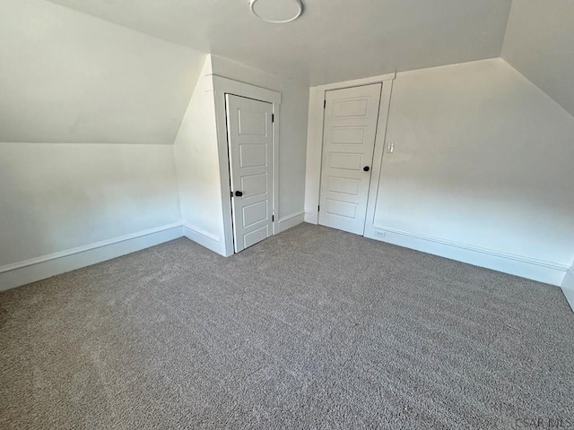 bonus room featuring carpet flooring and vaulted ceiling