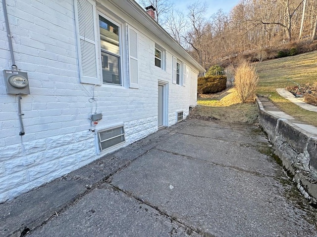 view of side of home featuring a patio area