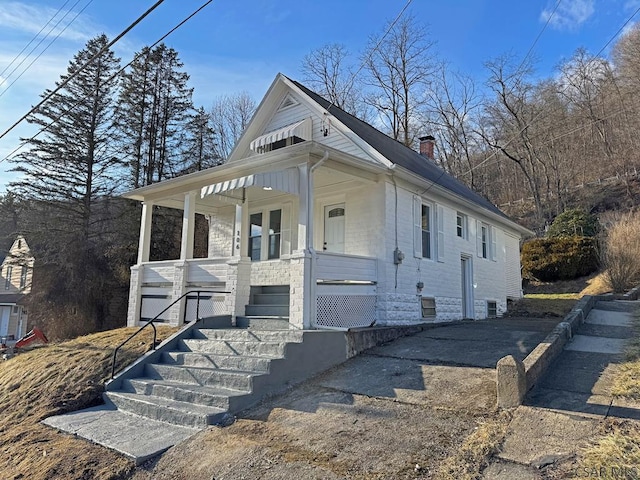 view of front of house with a garage and covered porch