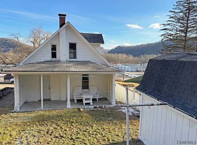 back of house with a yard and a patio area