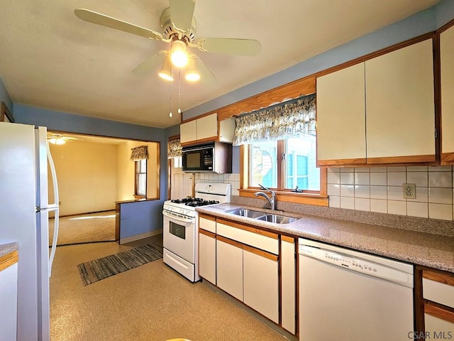 kitchen with a ceiling fan, a sink, tasteful backsplash, white appliances, and light countertops