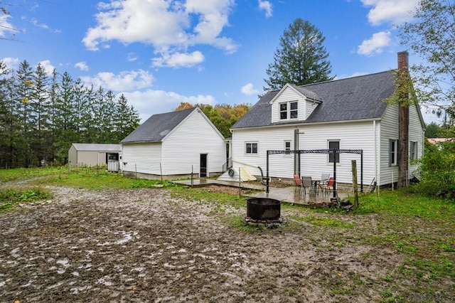 rear view of house with an outbuilding and a pergola