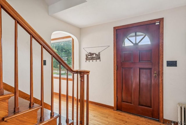 foyer entrance featuring radiator and light wood-type flooring