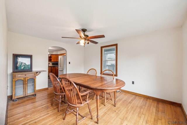 dining area with ceiling fan and light wood-type flooring