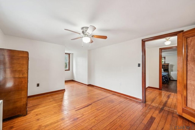 unfurnished room with ceiling fan and light wood-type flooring