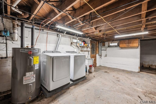 basement featuring washer and clothes dryer and water heater