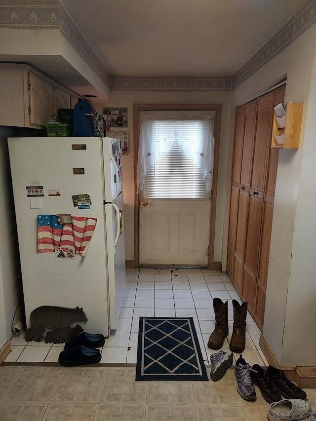 doorway with light tile patterned flooring