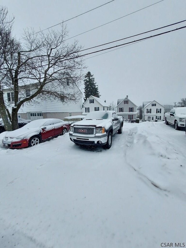 view of snow covered parking