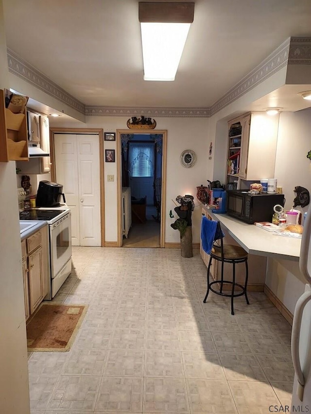 kitchen with white electric stove, black microwave, a breakfast bar area, under cabinet range hood, and open shelves