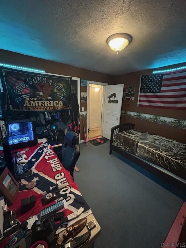 bedroom featuring carpet flooring and a textured ceiling